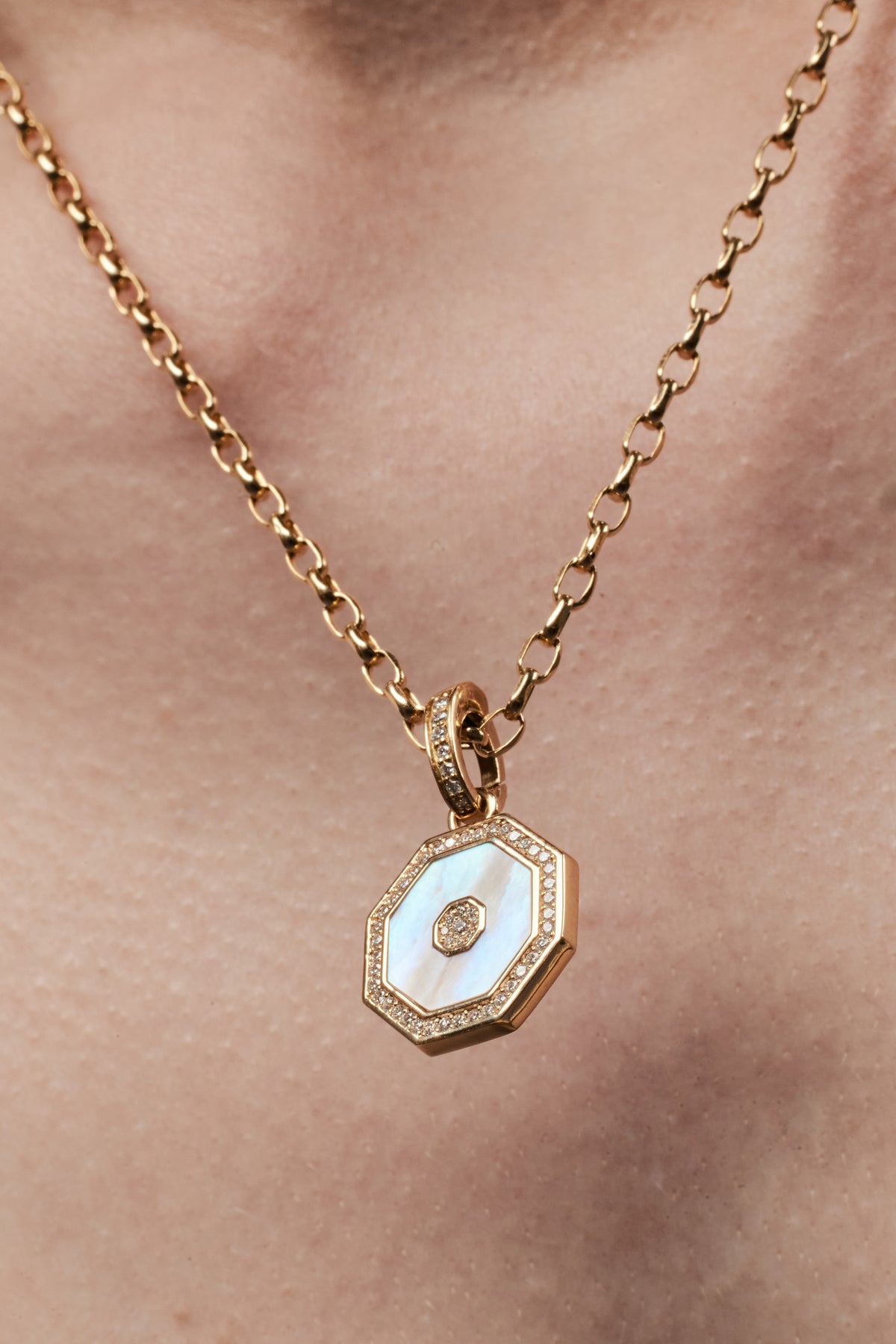 Octagon Pendant, White Mother of Pearl worn on a layered gold chain